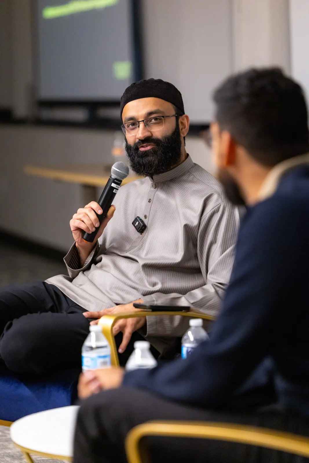 Nuun speaker holding a microphone during a community conversation
