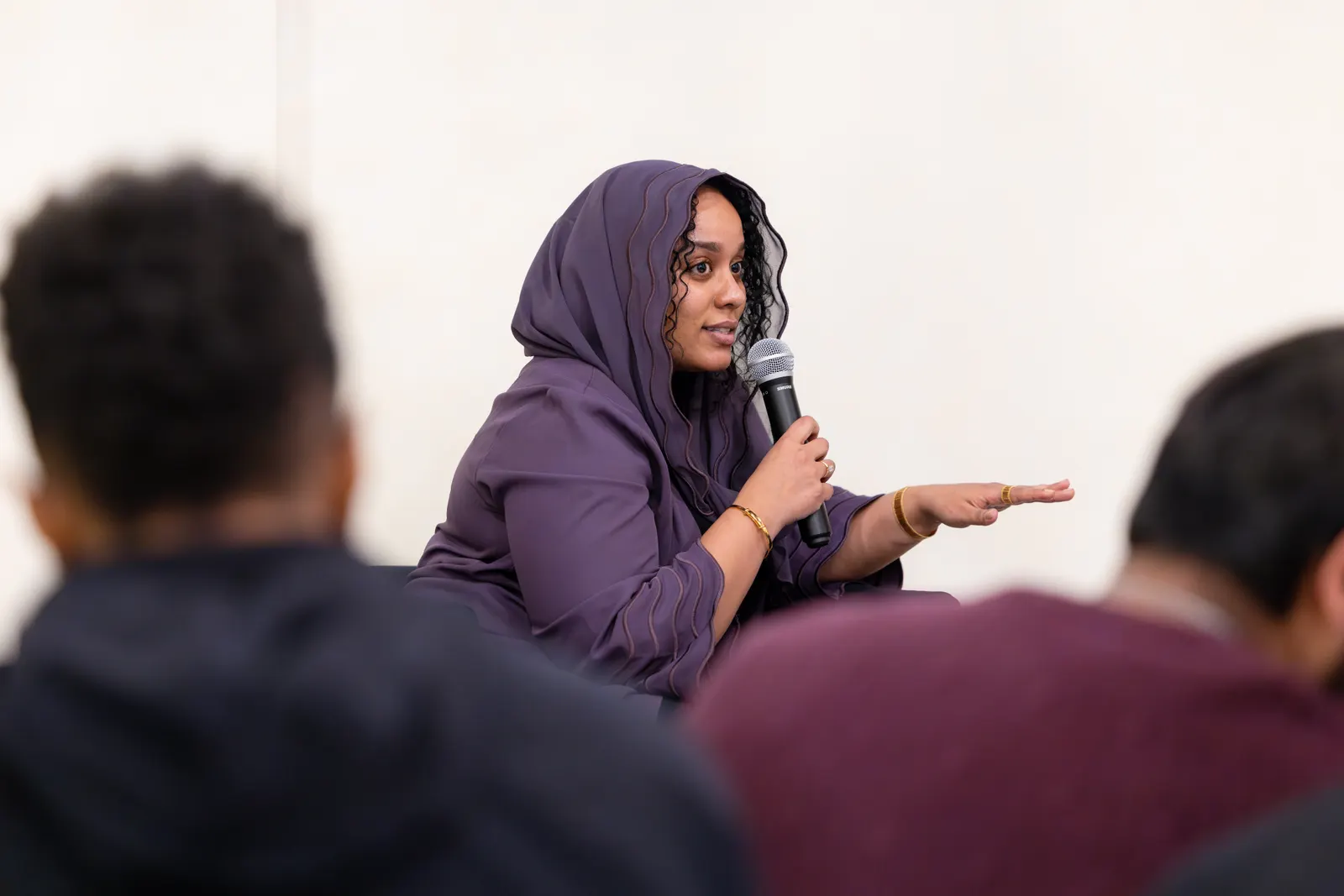 A woman speaking into a microphone during a Nuun discussion